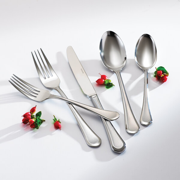 An Arcoroc stainless steel dinner spoon on a plate.