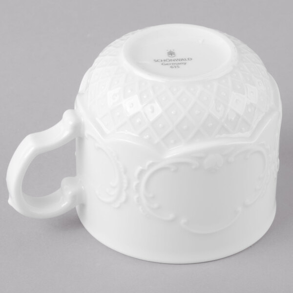 A white Schonwald porcelain cup with a handle.