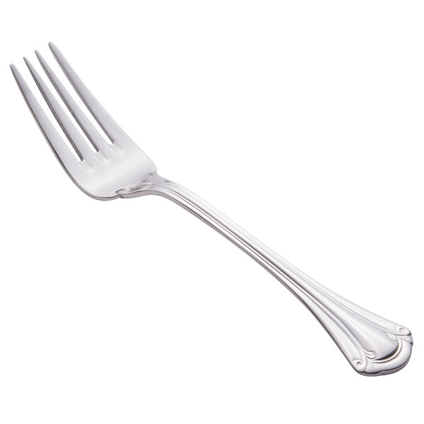 A close-up of a World Tableware Resplendence silver salad fork with a white handle.