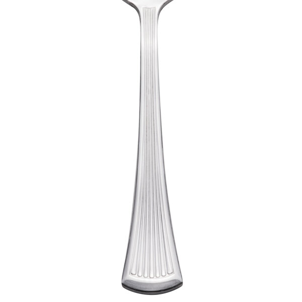 A Libbey stainless steel teaspoon with a curved design on the handle.
