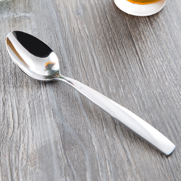 A Libbey stainless steel dessert spoon on a table.