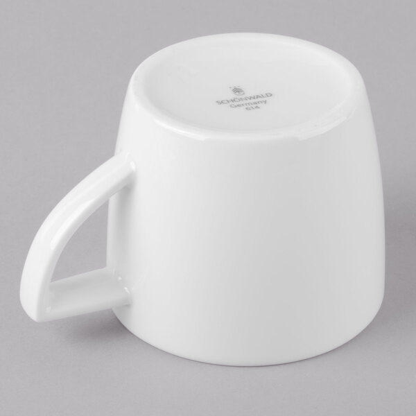 A white Schonwald porcelain cup with a handle.