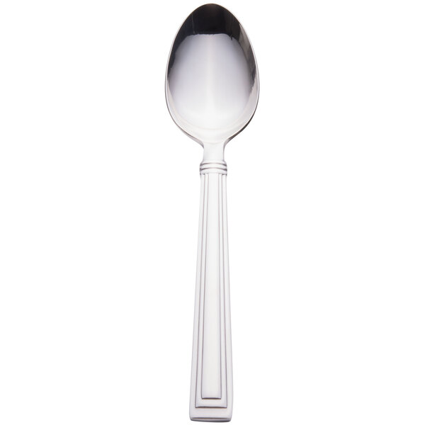 A silver dessert spoon with a white handle.