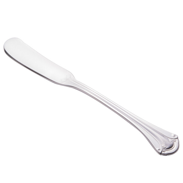 A silver World Tableware butter spreader with a white background.