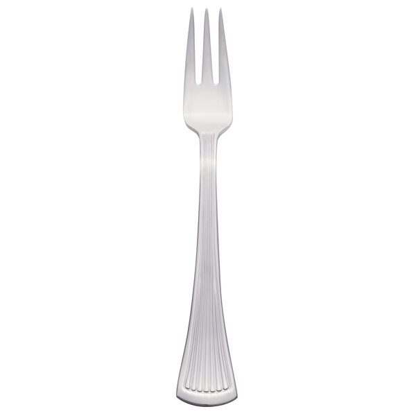 A silver Libbey cocktail fork with a white background.