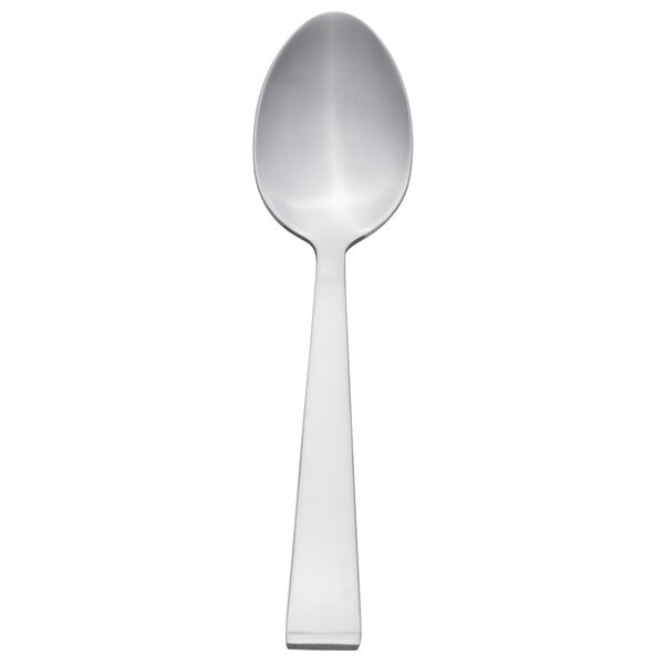 A Libbey stainless steel teaspoon with a white handle.