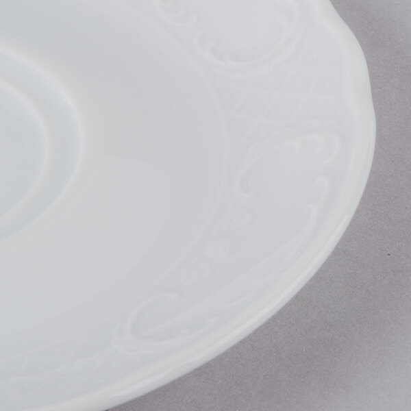 A Schonwald white porcelain saucer with a black swirl design.