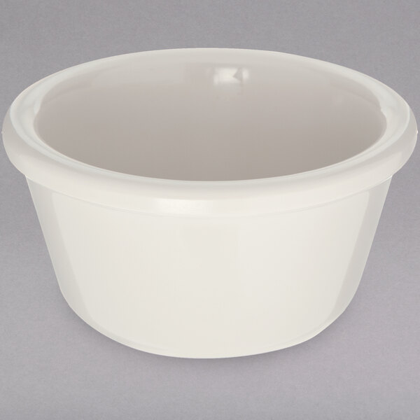 A white Carlisle ramekin with a white rim on a gray surface.