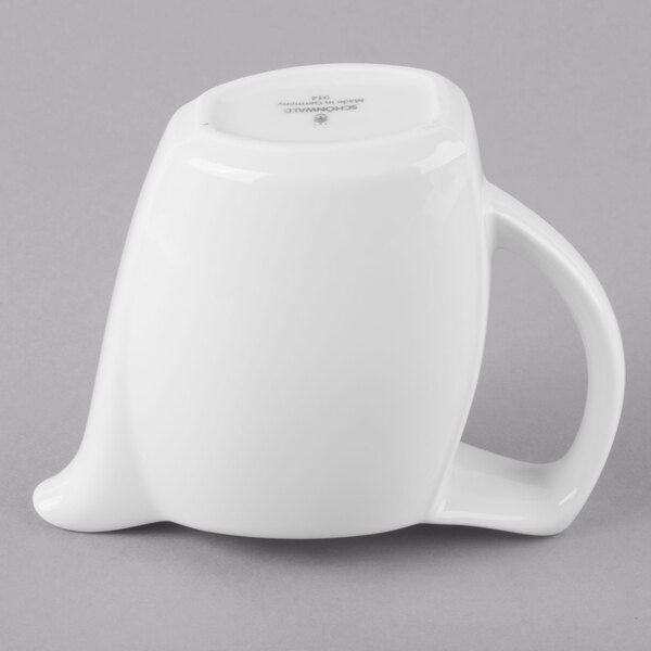 A Schonwald white porcelain creamer with a handle.