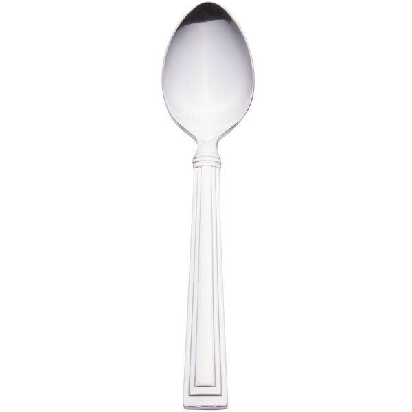 A silver Libbey stainless steel teaspoon with a white handle.