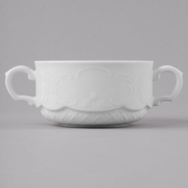 A white Schonwald porcelain soup cup with two handles.