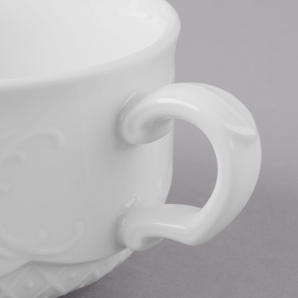 A close-up of a Schonwald white porcelain two-handled soup cup.