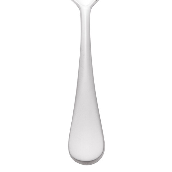 A Reserve by Libbey stainless steel demitasse spoon with a white handle.