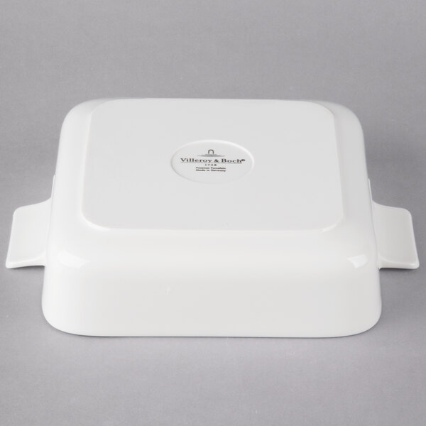 A white square porcelain serving dish with a lid.