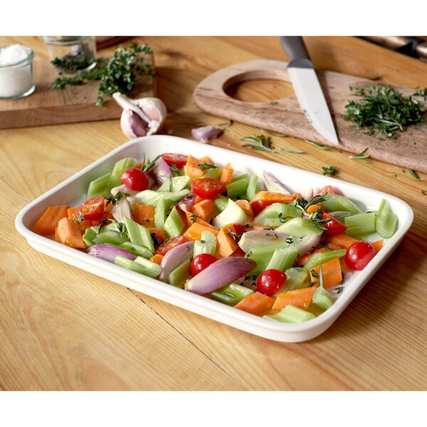 A Villeroy & Boch white porcelain rectangular serving plate with a lid containing a dish of vegetables.