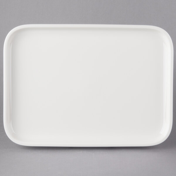 A white rectangular porcelain plate with a handle.