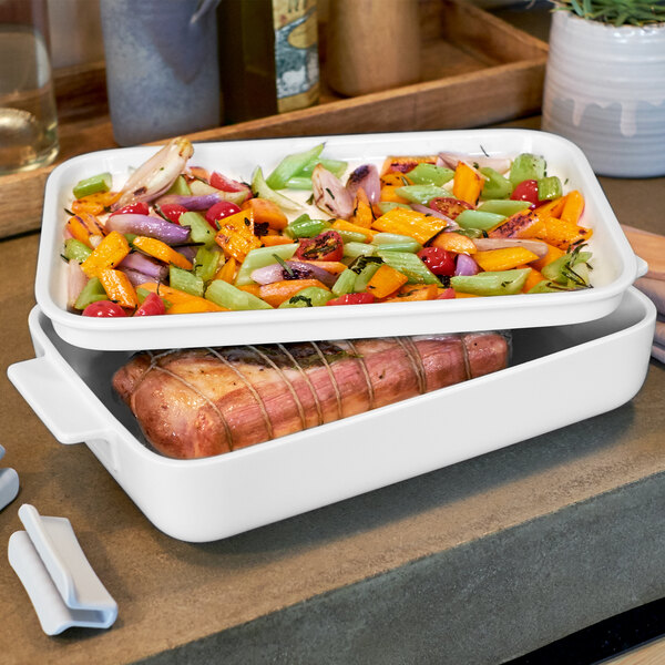 A Villeroy & Boch white porcelain rectangular serving plate with food in it.