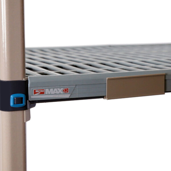 A MetroMax Q metal shelf with a blue plastic label holder attached.
