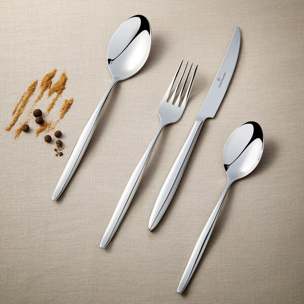 A Chef & Sommelier stainless steel dinner knife with a fork on a table.