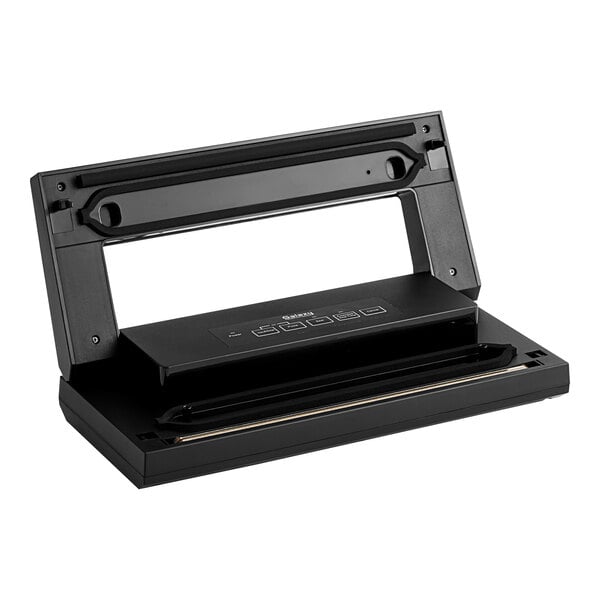 A black rectangular Galaxy VME1 vacuum packaging machine with buttons on a table.