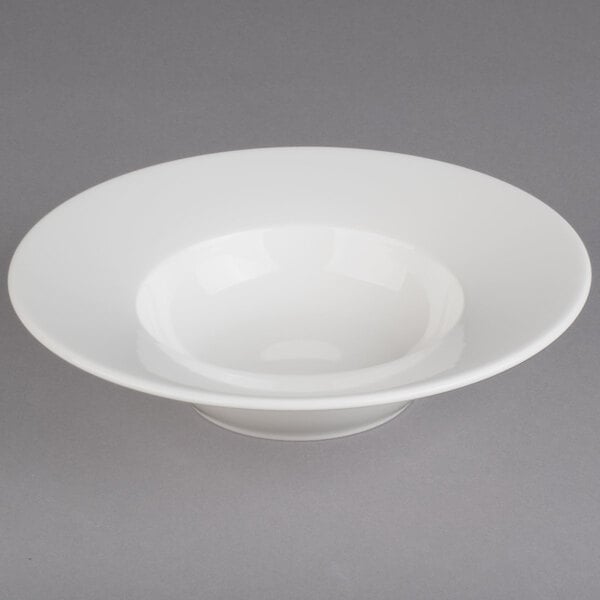 A close up of a Villeroy & Boch white porcelain bowl with a rim.
