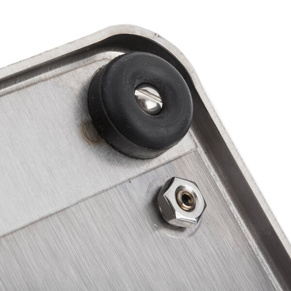 A close up of a metal plate with a black rubber ring.