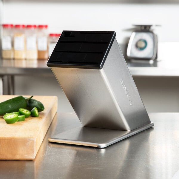 A Dexter-Russell stainless steel knife block on a counter.