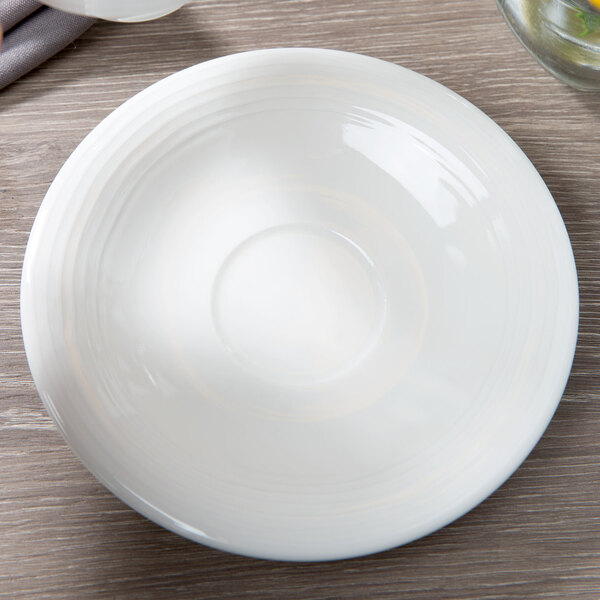 A white Villeroy & Boch porcelain saucer on a table.