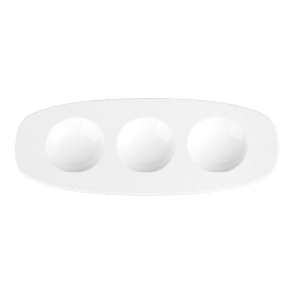 A white oval plate with three round compartments arranged in a row.