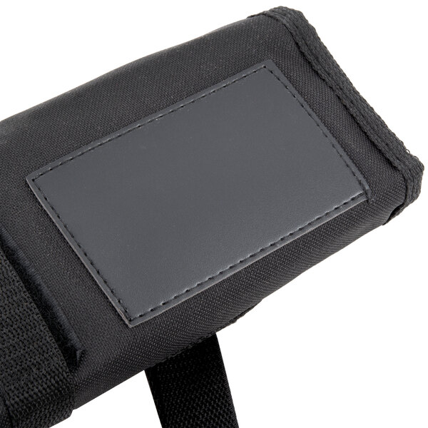 A black leather pouch with a black label holding Dexter-Russell SofGrip cutlery with white handles.