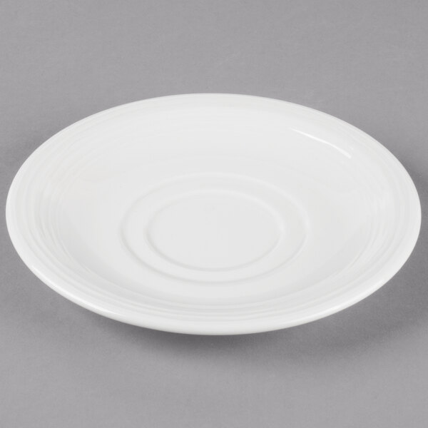A white porcelain saucer with a circular rim.