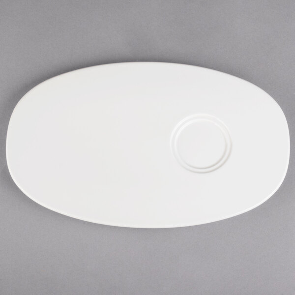A white oval plate with a circle on it.