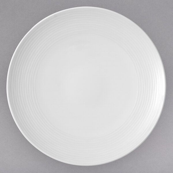 A white Villeroy & Boch porcelain coupe plate with a spiral pattern.