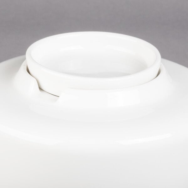 A white porcelain coffeepot with a lid.