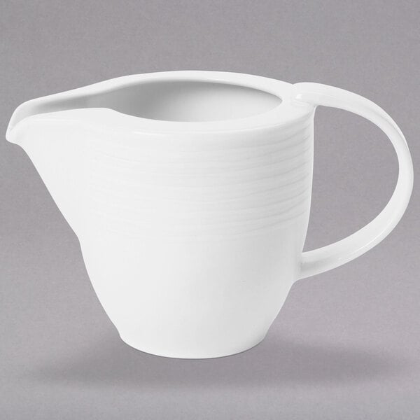 A Villeroy & Boch white porcelain creamer with a handle.