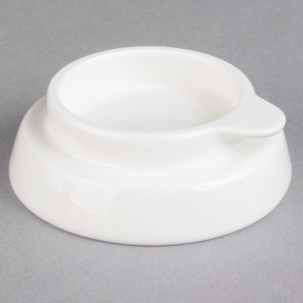 A white porcelain teapot with a lid and a handle.