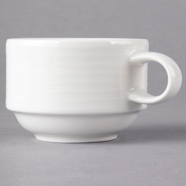 A close-up of a Villeroy & Boch white porcelain cup with a handle.