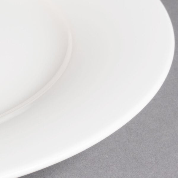 A close up of a Villeroy & Boch white porcelain plate with a white rim.