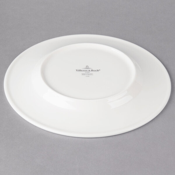A Villeroy & Boch white porcelain plate with a small white plate on it.
