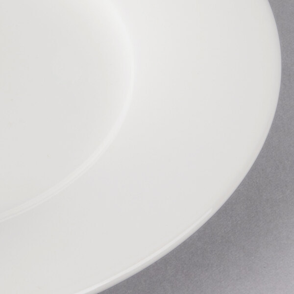 A close-up of a Villeroy & Boch white porcelain plate with a white rim.