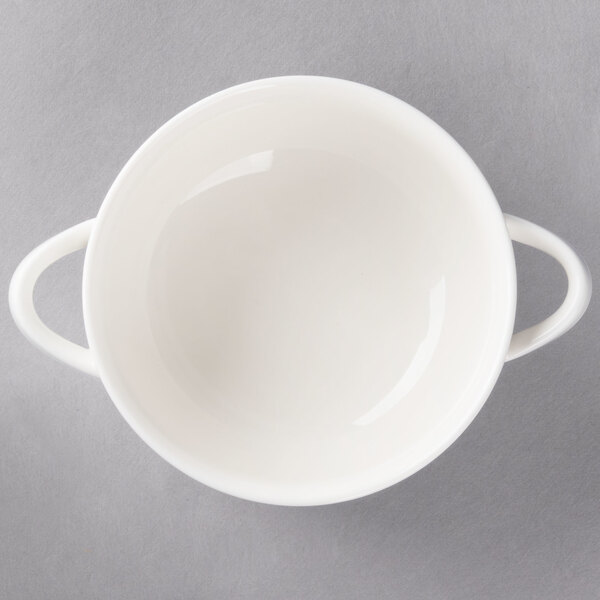 A white Villeroy & Boch porcelain soup cup with two handles.