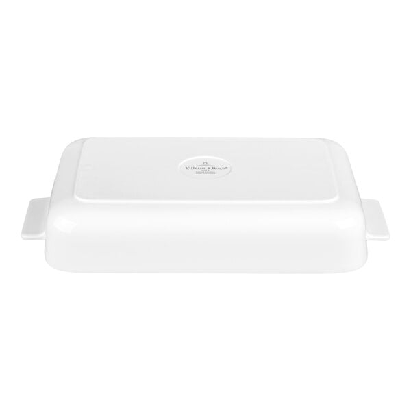 A white rectangular porcelain dish with handles on both sides, shown upside down.