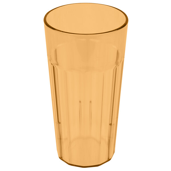 A close-up of a clear plastic tumbler with a brown rim.