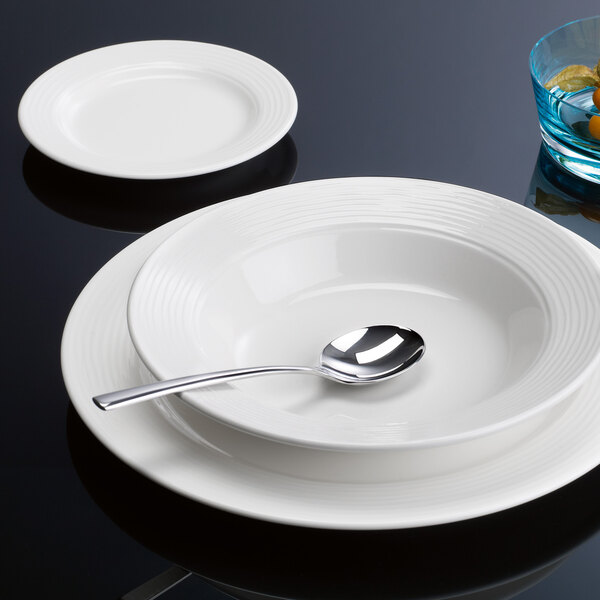 A white Villeroy & Boch Sedona porcelain plate with a spoon on it.