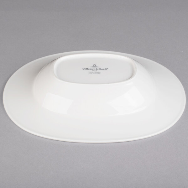 A white Villeroy & Boch porcelain oval bowl on a gray surface.