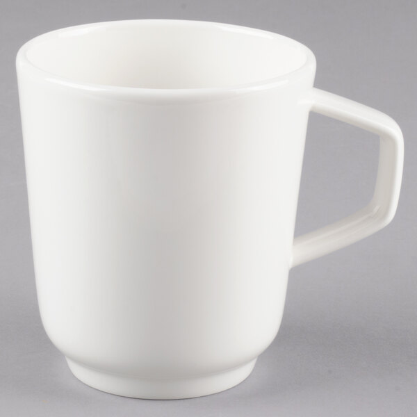 A close-up of a white Villeroy & Boch porcelain mug with a handle.