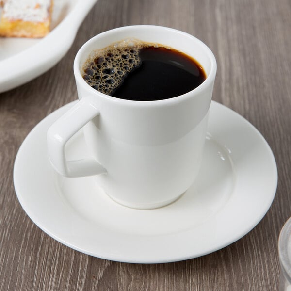 A Villeroy & Boch white porcelain mug of coffee on a saucer.