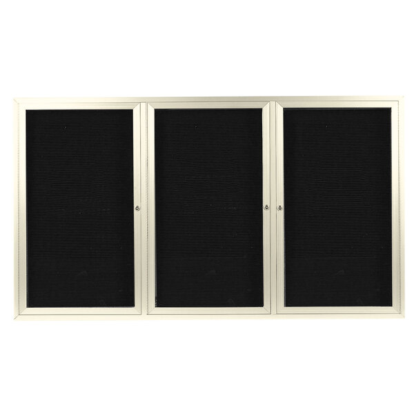 A white board with black doors and a black letter board.