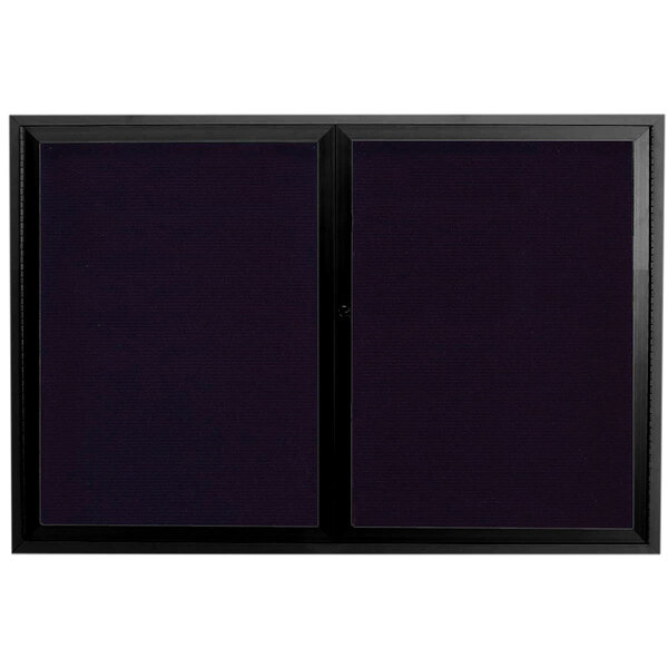 A black rectangular message center with black trim on two glass doors.