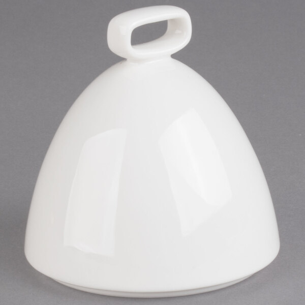 A white bell shaped object with a handle.